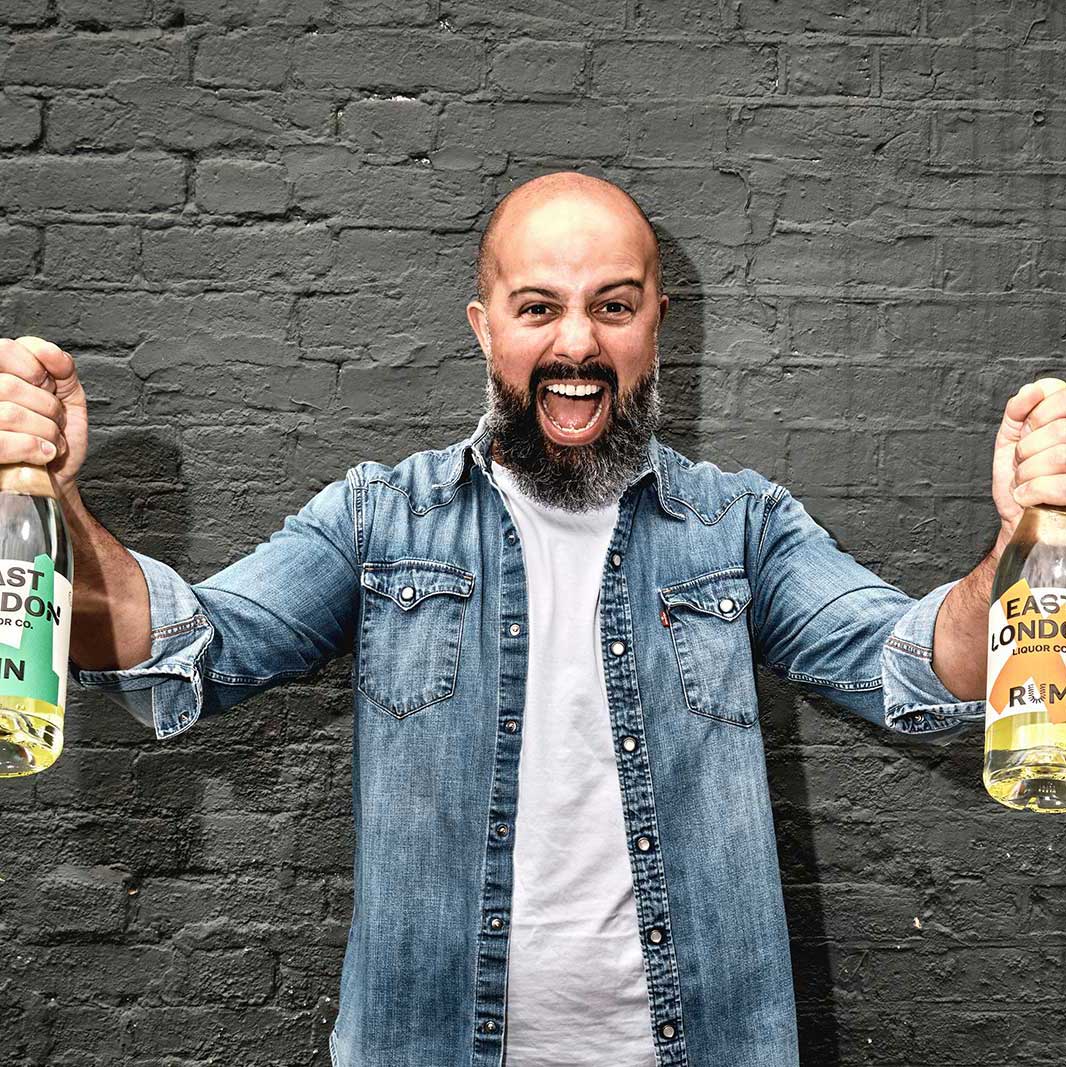 Alex from East London Liquour Company with gin bottles
